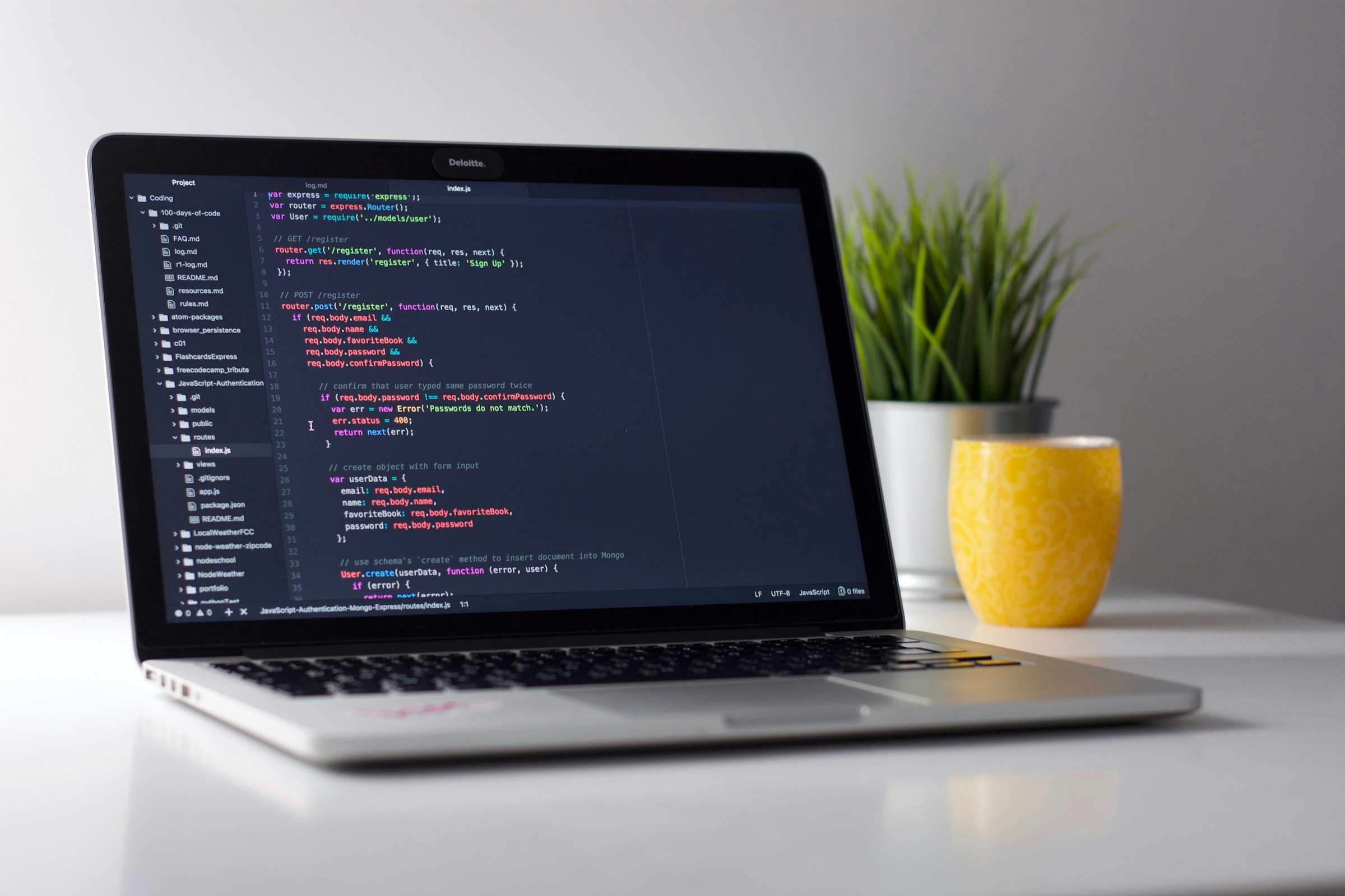 Developer workspace with laptop displaying code in a focused environment